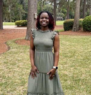 Alumna Carol Wallace posing in backyard